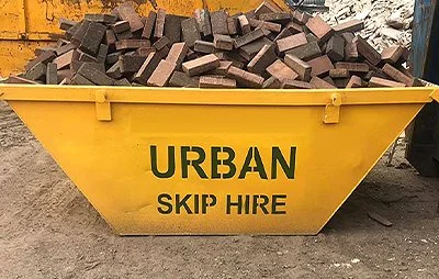 Original Urban yellow skip filled with bricks